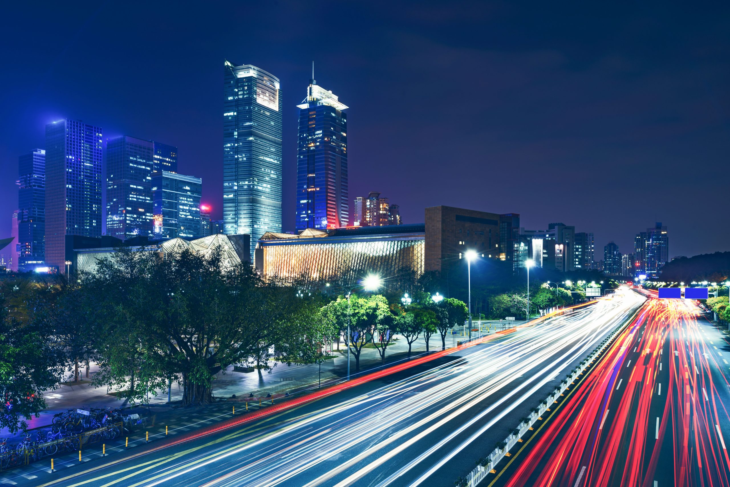 Smart city skyline at night with connected street lighting and traffic analytics